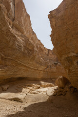 Picturesque view of sunlit Tamaghza canyon with imposing sandstone cliffs standing as timeless monuments to sculpting forces of nature in Tunisia