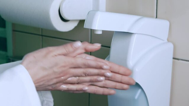 Coronavirus spread prevention. Doctor using alcohol rub as alternative to washing hands