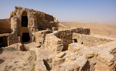 View of old Ksar Beni Barka settlement with ruined storage areas in Tunisia