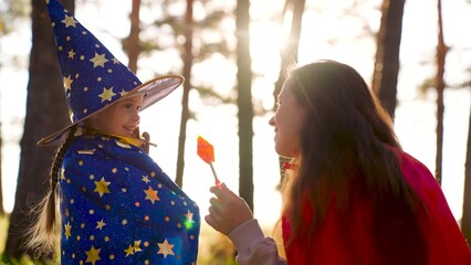 Childhood dreams, fantasies to become wizard. Child plays with his mother in costumes of wizard,...