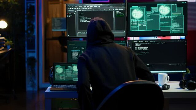 Hacker arriving in hidden underground shelter with laptop, prepared to launch malware attack on websites. Scammer in apartment starting work on dangerous script that can breach security, camera A