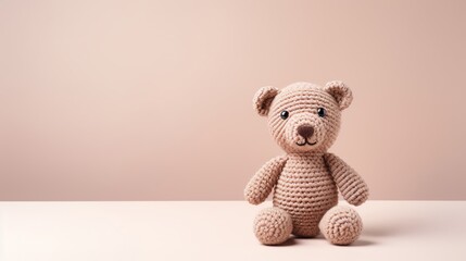 Cute and cuddly crocheted teddy bear made from beige yarn.