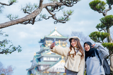 Travel, muslim travel, woman girl tourist Two Asian friends but different religions walking at...