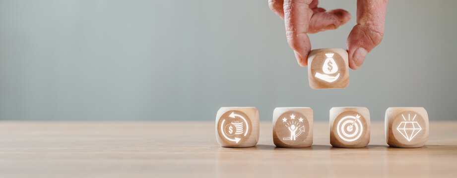 Lean thinking concept, Hand holding wooden block on desk with value, value stream, flow, pull and perfection icon on virtual screen.