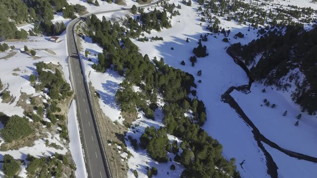Pass road on the Lukmanier Pass in late winter with a view of a protective structure, road protection against debris flow, drone image, Vallone di Casaccia, Ticino, Switzerland, Europe