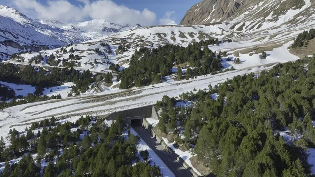 Pass road on the Lukmanier Pass in late winter with a view over a protective structure of the pass road, drone image, Vallone di Casaccia, Ticino, Switzerland, Europe