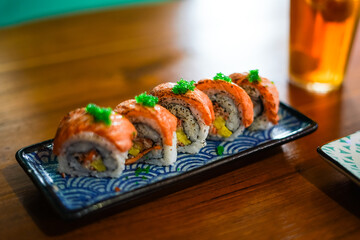 sushi roll topped wit salmon, Japanese traditional dishes, selective focus