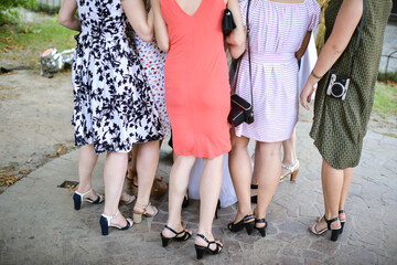 Group of girls in dresses and high heels at a party