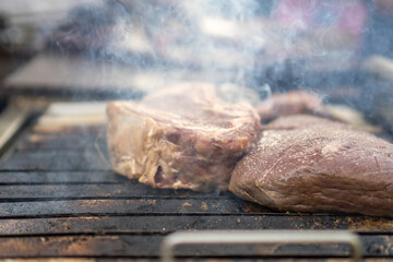 Meat on smoky grill in a barbecue