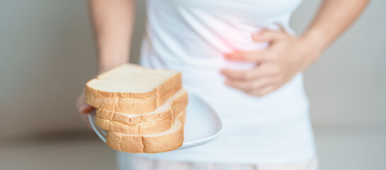 Gluten intolerance, Gluten free and celiac disease or wheat allergy concept. woman hold Bread and...