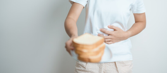 Gluten intolerance, Gluten free and celiac disease or wheat allergy concept. woman hold Bread and...