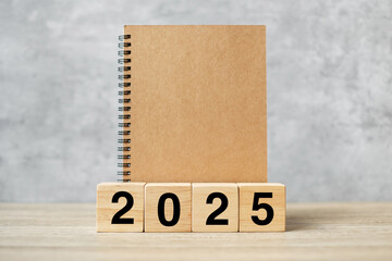 2025 Happy New Year with blank notebook and wooden number. countdown, Resolution, Goals, Plan, Action and Mission Concept