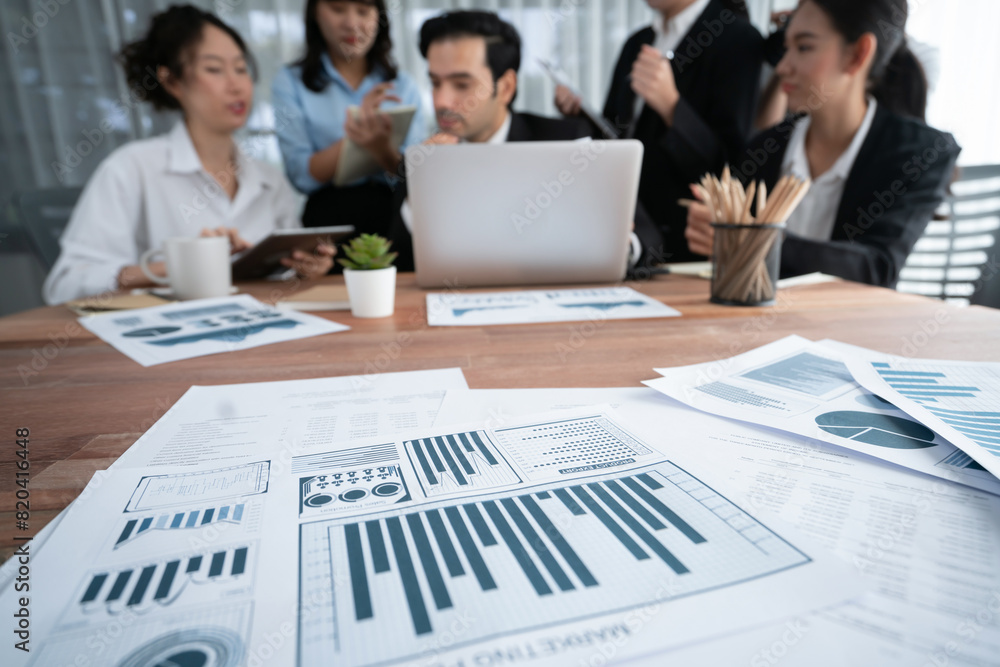 Aufkleber piles of analyzed financial data dashboard on meeting table with background of business people analy