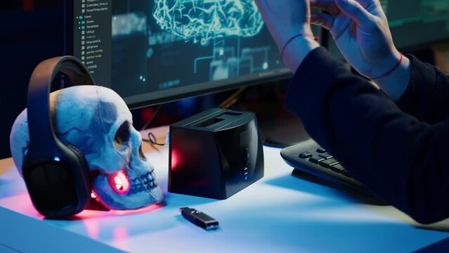Hacker uploading script on SSD that can launch DDoS attacks on any website. Cybercriminal writing program that can crash servers, downloading it on storage drive, camera A