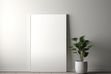 Minimalist blank canvas leaning against a white wall with a potted plant nearby, perfect for adding custom artwork or design in a modern setting.