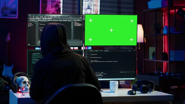 Cybercriminal uploading USB flash drive containing stolen information into green screen computer. Scammer inserting storage device into chroma key PC with data obtained from security breach, camera A