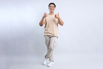 Full Body Of Stylish Young Asian Guy Giving Thumbs Up Isolated On White Background