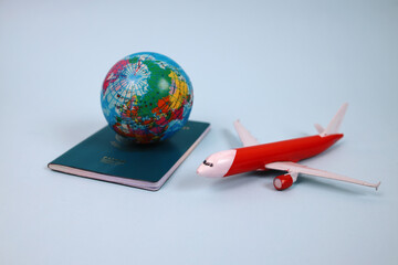 Traveling Around The World. Globe On Passport And Airplane Over Blue Background. 