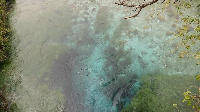 Clear transparent turquoise water in deep pool of natural karst spring of Blue Eye (Syri i Kalter) near Sarande. Popular tourist attraction of Albania