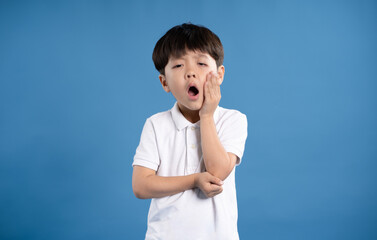 Portrait of asian boy posing on blue background