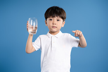 Portrait of asian boy posing on blue background