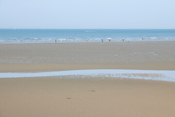 View of the seaside with the tourists on the beach