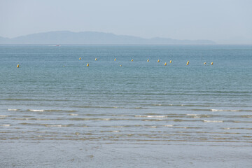 View of the sea with the floating buoys