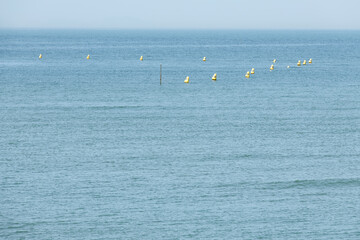 View of the sea with the floating buoys