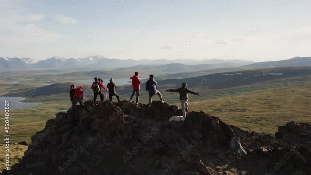 Aufkleber big group of diverse tourists or hikers are standing on mountain top with great view at valley with 