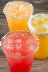 A closeup view of three cold aguas frescas, featuring watermelon, cantaloupe, and pineapple.