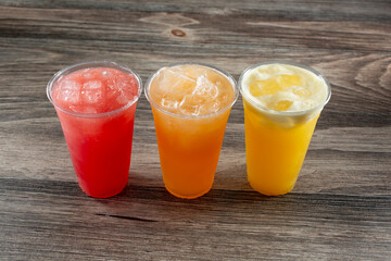 A view of three cold aguas frescas, featuring watermelon, cantaloupe, and pineapple.