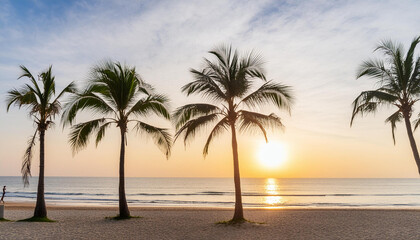 Silhouette of coconut trees on the beach at sunrise
