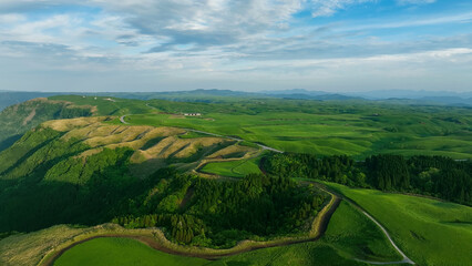 Drone aerial shots of spectacular greenery landscapes and blue sky. Dynamic natural scenery.