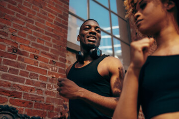 Close-up shot of a woman jogger running past a man