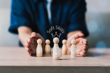 A person is holding a wooden figure of a person with a crown on top of a table