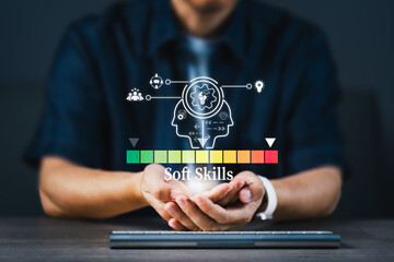 A man is holding a graph showing a scale of soft skills level and white icons