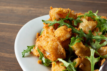 A closeup view of a plate of deep fried calamari.
