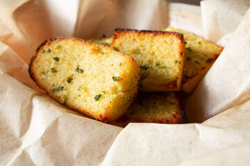 A closeup view of a basket of garlic bread.