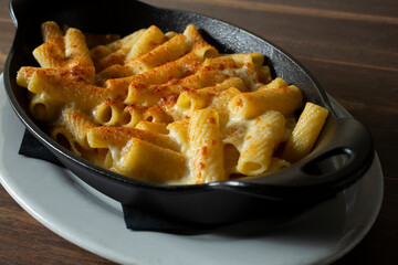 A view of a skillet of rigatoni and cheese.