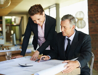 Businessman, architect and blueprints with office, discussion and collaboration for engineering project. Mature woman, man and plans with teamwork, blueprints and review for construction design