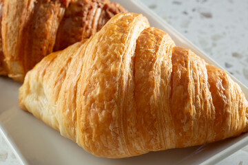 A closeup view of a plate of croissants.
