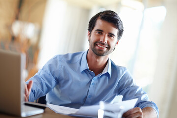 Documents, laptop and portrait of businessman in office for research on budget planning for startup company. Paperwork, computer and male financial advisor working on corporate payroll in workplace.