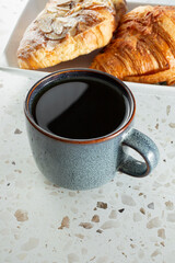 A view of a rustic mug filled with black coffee.
