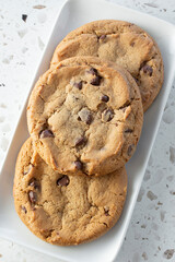 A top down view of a plate of chocolate chip cookies.