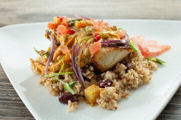 A view of a plate of curry fish.
