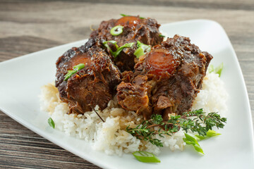 A closeup view of a plate of oxtails.