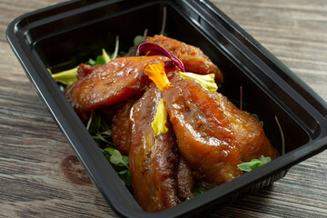A closeup view of a container of fried plantains.