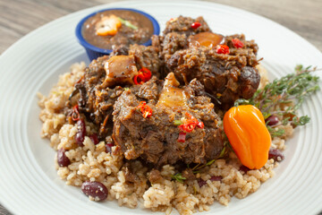 A closeup view of a plate of jerk oxtail.
