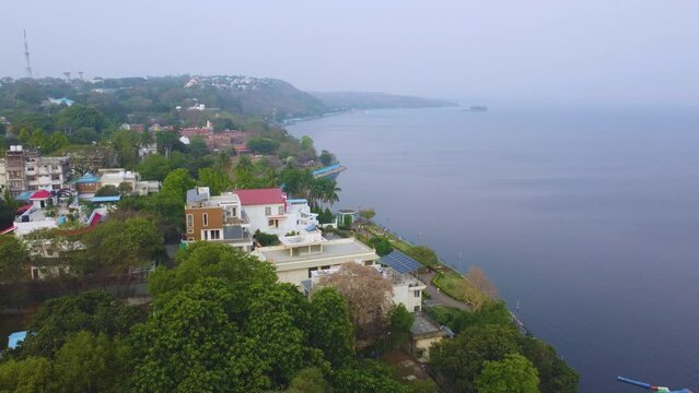 Aerial drone shot of resedential buildings around upper lake of bhopal capital city of madhya pradesh during morning time in India