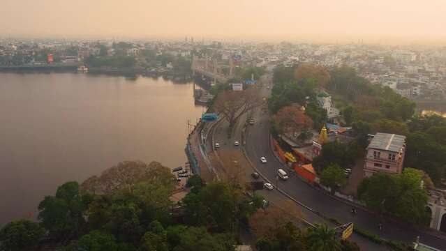 Aerial drone shot of bhopal capital city of madhya pradesh with upper lake and downtown roads with car traffic in india